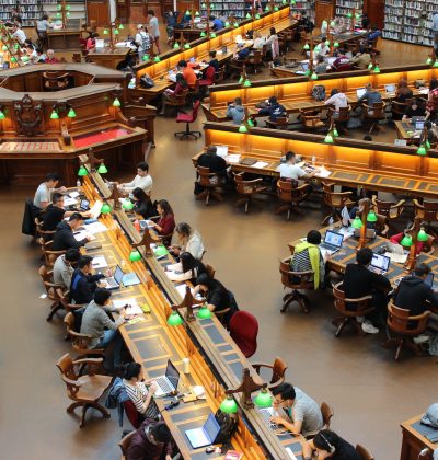 Library and study room full of people working and searching books
